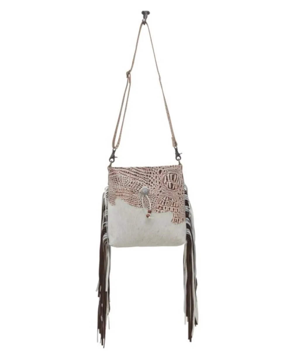 cowhide hand bag with leather strap and fringe